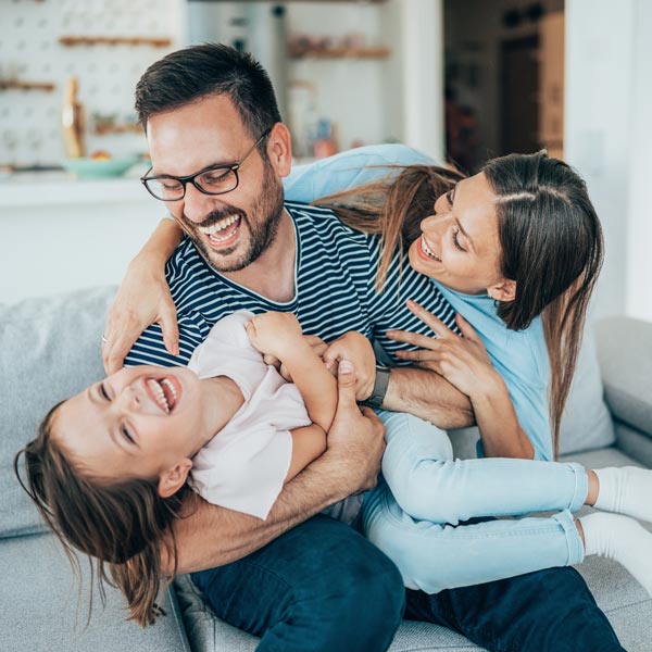 laughing family of three