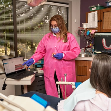 dental hygienist with patient